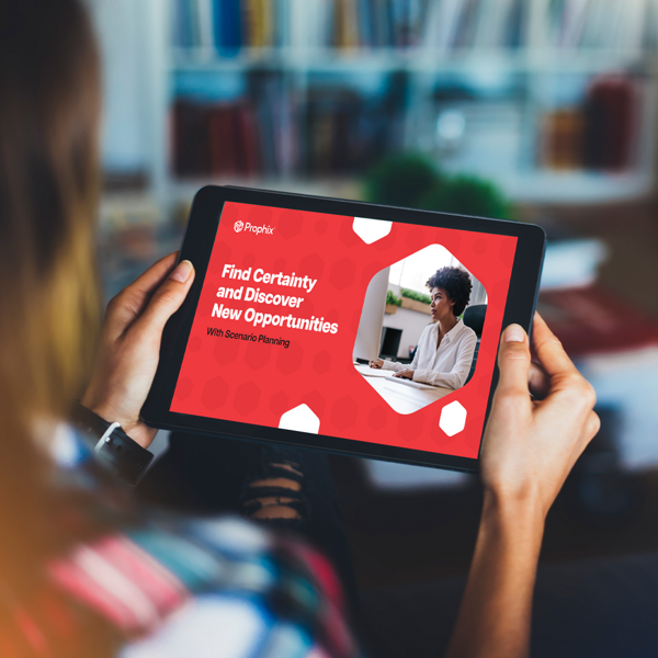 A woman holding an iPad displaying a book cover.
