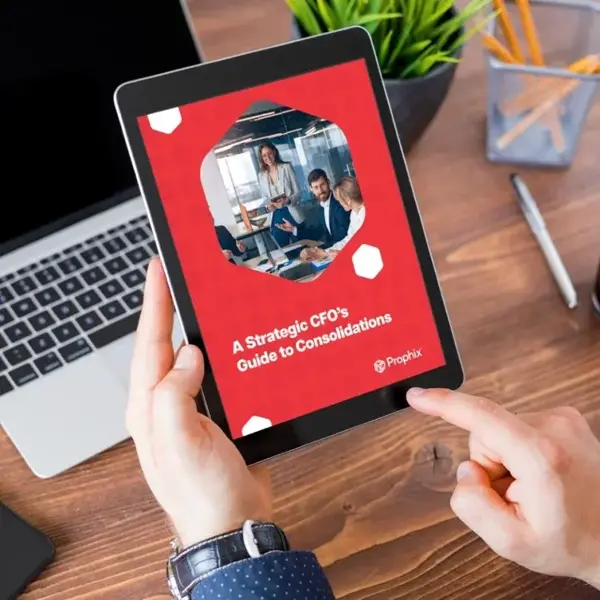 A person holding an iPad, showing a picture of a group of professionals collaborating on the screen