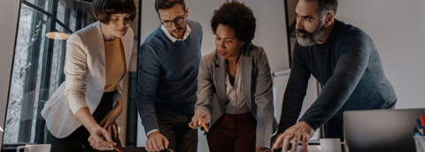 A diverse team collaborating in a modern office, working together to achieve their goals