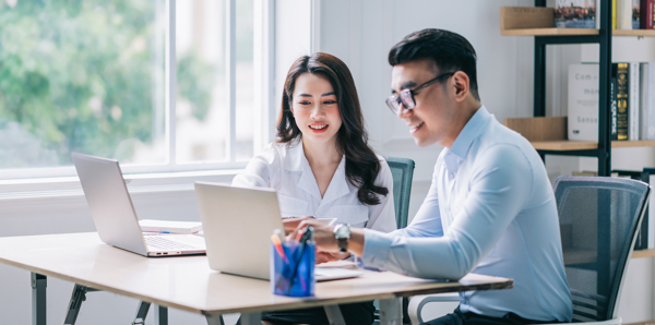 Business Team and IT Professional Using Laptop