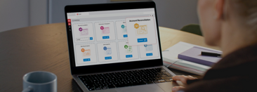 Image 61: A person using Prophix One Account Reconciliations AI powered transaction matching feature on their laptop computer