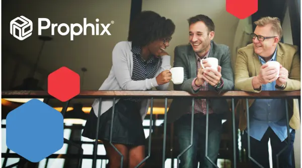 Tres profesionales se sientan juntos en una cafetera, sosteniendo tazas de caf y riendo mientras se miran