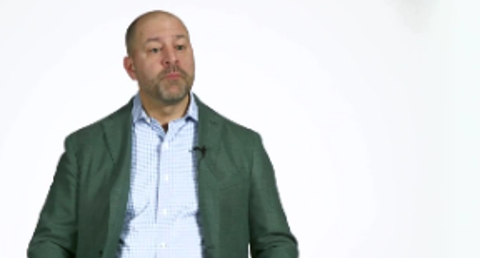 A man seated with a serious expression - American Library Association - Video Cover Image