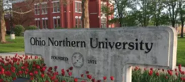 Front entrance of Ohio Nothern University building, surrounded by flowers