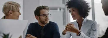 Four team members sitting together and discussing reports