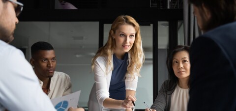 A woman addressing a group of people, engaging in a conversation or delivering a presentation