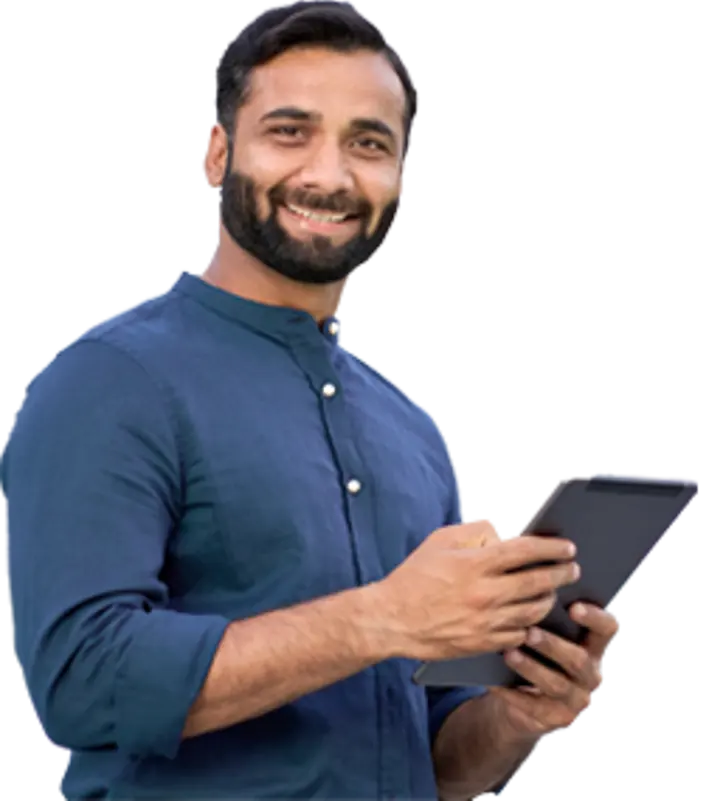 A man happily using a tablet computer while enjoying the outdoors.