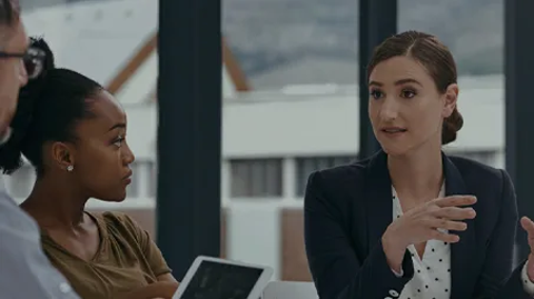Professional woman speaking and explaining something to her two colleagues