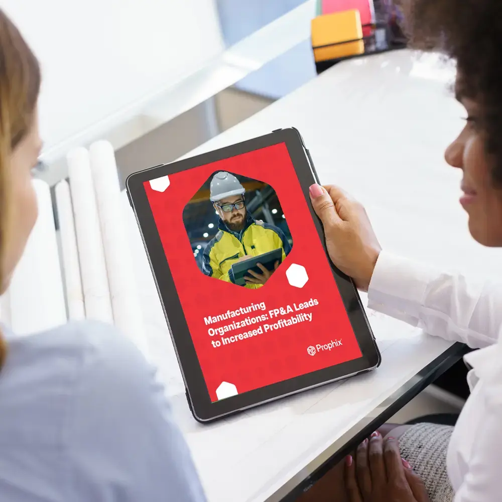Manufacturers Use Insights from Data Two women in safety gear examining a tablet computer, possibly discussing safety procedures.
