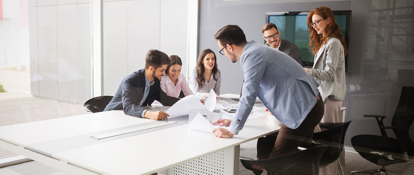 A diverse group of professionals engaged in a productive meeting within a conference room